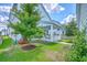 Spacious backyard with covered porch, landscaping and green grass to enjoy outdoor living at 312 Cypress Knee Landing, Summerville, SC 29483