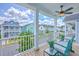 Enjoy the view from this charming balcony with seating and a ceiling fan overlooking the neighborhood at 312 Cypress Knee Landing, Summerville, SC 29483