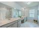 Bright bathroom featuring double sink vanity, marble floors, and a glass-enclosed shower for modern convenience at 312 Cypress Knee Landing, Summerville, SC 29483