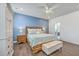 A beautifully decorated bedroom features hardwood floors, a ceiling fan, and an upholstered storage bench at 312 Cypress Knee Landing, Summerville, SC 29483