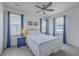 Bright bedroom featuring neutral walls, plush carpet, ceiling fan, and two windows providing natural light at 312 Cypress Knee Landing, Summerville, SC 29483