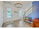 Spacious foyer with hardwood floors, natural light, an elegant chandelier and a staircase to the upper level at 312 Cypress Knee Landing, Summerville, SC 29483
