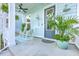 Inviting front porch with rocking chairs, ceiling fan, and decorative plants offering a relaxing outdoor space at 312 Cypress Knee Landing, Summerville, SC 29483
