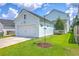 A detached garage with a white door is next to the home at 312 Cypress Knee Landing, Summerville, SC 29483