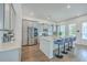 Modern kitchen with stainless steel appliances, gray cabinets, a center island and four counter stools at 312 Cypress Knee Landing, Summerville, SC 29483