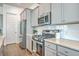 Modern kitchen with stainless steel appliances, white subway tile backsplash and gray cabinets at 312 Cypress Knee Landing, Summerville, SC 29483