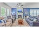 Comfortable living room with a fireplace, ceiling fan, and stylish blue couches on a decorative rug at 312 Cypress Knee Landing, Summerville, SC 29483