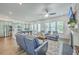 Bright open-concept living room features modern furnishings, ceiling fan, and seamless flow to kitchen at 312 Cypress Knee Landing, Summerville, SC 29483