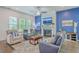 Cozy living room featuring hardwood floors, shiplap accent wall with fireplace, furniture, and a ceiling fan at 312 Cypress Knee Landing, Summerville, SC 29483