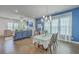 Open concept living area featuring blue accent wall, fireplace, tv, living room, dining room and hardwood floors at 312 Cypress Knee Landing, Summerville, SC 29483