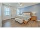 Comfortable main bedroom with hardwood floors, natural light, and a stylish blue accent wall and a bench at 312 Cypress Knee Landing, Summerville, SC 29483