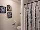 Chic bathroom features modern black and white shower curtain with framed perfume art at 317 Whispering Breeze Ln, Summerville, SC 29486