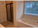 Bathroom showcasing soaking tub with tile surround and a shower at 317 Whispering Breeze Ln, Summerville, SC 29486