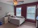 Bright bedroom with two windows, ceiling fan, and a comfortable queen-sized bed at 317 Whispering Breeze Ln, Summerville, SC 29486