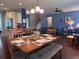 A wooden dining room table is surrounded by seats and placed on hardwood floors at 317 Whispering Breeze Ln, Summerville, SC 29486