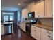 A modern kitchen offers stainless appliances, granite countertops and white cabinetry at 317 Whispering Breeze Ln, Summerville, SC 29486