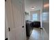 Well-lit laundry room with modern appliances and convenient shelving at 317 Whispering Breeze Ln, Summerville, SC 29486