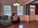 This living room has seating, a gaming desk, and windows that let in natural light at 317 Whispering Breeze Ln, Summerville, SC 29486