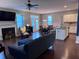 Open-concept living room with a fireplace, dining area, and modern kitchen, great for entertaining at 317 Whispering Breeze Ln, Summerville, SC 29486