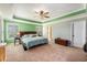 Bright main bedroom showcasing decorative tray ceiling with a fan at 317 Whispering Breeze Ln, Summerville, SC 29486