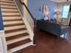 Elegant staircase with hardwood steps and white risers, complemented by blue walls and modern decor at 317 Whispering Breeze Ln, Summerville, SC 29486