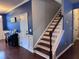 Elegant staircase with hardwood steps and white risers, complemented by blue walls and modern decor at 317 Whispering Breeze Ln, Summerville, SC 29486