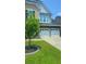 Two car garage with white doors, a stone facade, and a manicured lawn at 322 Braken Fern Rd, Moncks Corner, SC 29461