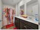 Charming bathroom featuring double vanity with framed mirrors and unique shower curtain at 324 Spruce Ivy St, Moncks Corner, SC 29461