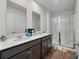Well-lit bathroom features double sinks, granite countertops, and a glass-enclosed shower at 324 Spruce Ivy St, Moncks Corner, SC 29461