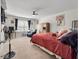 Comfortable bedroom with natural light, ceiling fan, sitting area, and warm-toned decor at 324 Spruce Ivy St, Moncks Corner, SC 29461