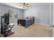 Bedroom featuring soft carpet, a ceiling fan, and a wooden-framed bed bathed in natural light at 324 Spruce Ivy St, Moncks Corner, SC 29461
