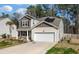 Beautiful two-story home with a two-car garage, manicured lawn, and solar panels for energy efficiency at 324 Spruce Ivy St, Moncks Corner, SC 29461