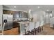 Open kitchen boasts stainless steel appliances, granite countertops, and a central island with barstool seating at 324 Spruce Ivy St, Moncks Corner, SC 29461