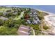 Stunning aerial view of a beach home surrounded by lush greenery and a golf course nearby at 341 Seabrook Island Rd, Seabrook Island, SC 29455