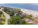 Aerial view of coastal home with beach access, surrounded by lush greenery, offering stunning ocean views at 341 Seabrook Island Rd, Seabrook Island, SC 29455