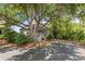 Charming exterior of home, shaded by mature trees, features a welcoming entryway and lush landscaping at 341 Seabrook Island Rd, Seabrook Island, SC 29455