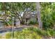 Charming exterior of home, shaded by mature trees, features a welcoming entryway and lush landscaping at 341 Seabrook Island Rd, Seabrook Island, SC 29455