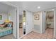 Hallway showcasing mirror, tiled flooring, and doorways leading to the bedroom and other spaces at 341 Seabrook Island Rd, Seabrook Island, SC 29455