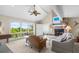 Bright living room with a fireplace, large windows with scenic views, and comfortable seating area at 341 Seabrook Island Rd, Seabrook Island, SC 29455