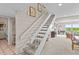 Bright staircase with white railings leading to a living area with scenic water views at 341 Seabrook Island Rd, Seabrook Island, SC 29455
