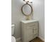 Modern bathroom vanity with a gold faucet, round mirror, and stylish lighting fixture at 400 Tammie Ave, Goose Creek, SC 29445