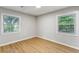 Bright bedroom features hardwood floors and two windows, offering plenty of natural light at 400 Tammie Ave, Goose Creek, SC 29445