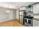 Kitchen featuring stainless steel appliances, white cabinets, butcher block countertops, and an eye-catching wicker pendant light at 400 Tammie Ave, Goose Creek, SC 29445