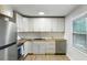 Bright and modern kitchen featuring white cabinets, butcher block countertops, stainless steel appliances, and new backsplash at 400 Tammie Ave, Goose Creek, SC 29445