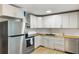 Modern kitchen with white cabinets, stainless steel appliances, butcher block counters, and tile backsplash at 400 Tammie Ave, Goose Creek, SC 29445