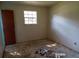 A basic bedroom featuring a window and debris on the floor at 403 Bryan St, Summerville, SC 29483