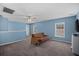 Spacious bonus room with a comfortable couch, ceiling fan, and neutral carpeting, offering versatile living space at 406 Brookfield Ln, Goose Creek, SC 29445