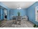 Stylish dining area features gray wood-look flooring and coordinated furniture at 406 Brookfield Ln, Goose Creek, SC 29445