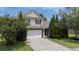 Charming two-story home featuring a driveway and a well-manicured front yard with lush greenery at 406 Brookfield Ln, Goose Creek, SC 29445