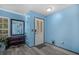 Bright blue foyer with a decorative mirror and stylish gray wood-look flooring at 406 Brookfield Ln, Goose Creek, SC 29445